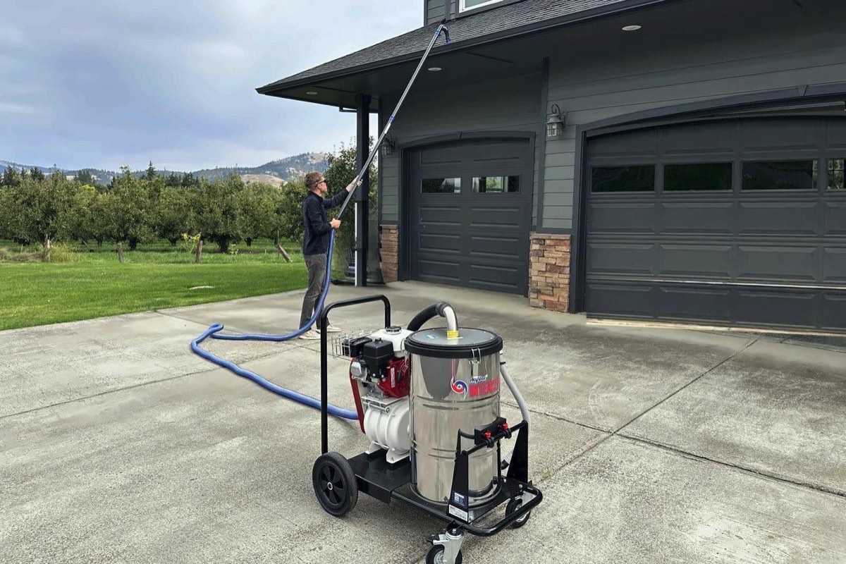 Commercial gutter vacuum clearing gutters from the ground